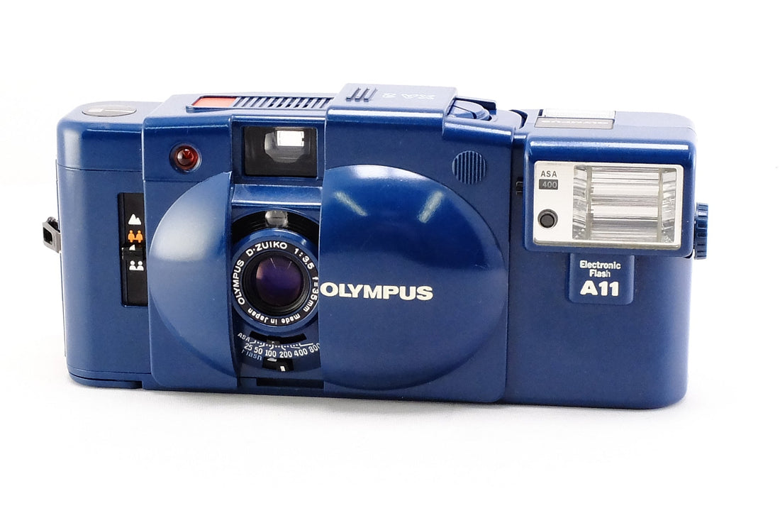 Olympus XA-2 camera in blue, compact design ideal for pocket travel and outdoor photography with Kodak ColorPlus 200.