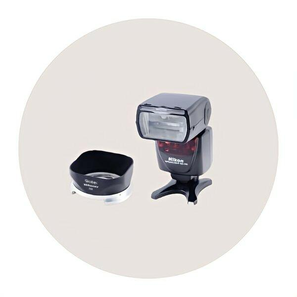 Nikon camera flash with lens hood, essential accessory for photographers, enhancing lighting and creativity.