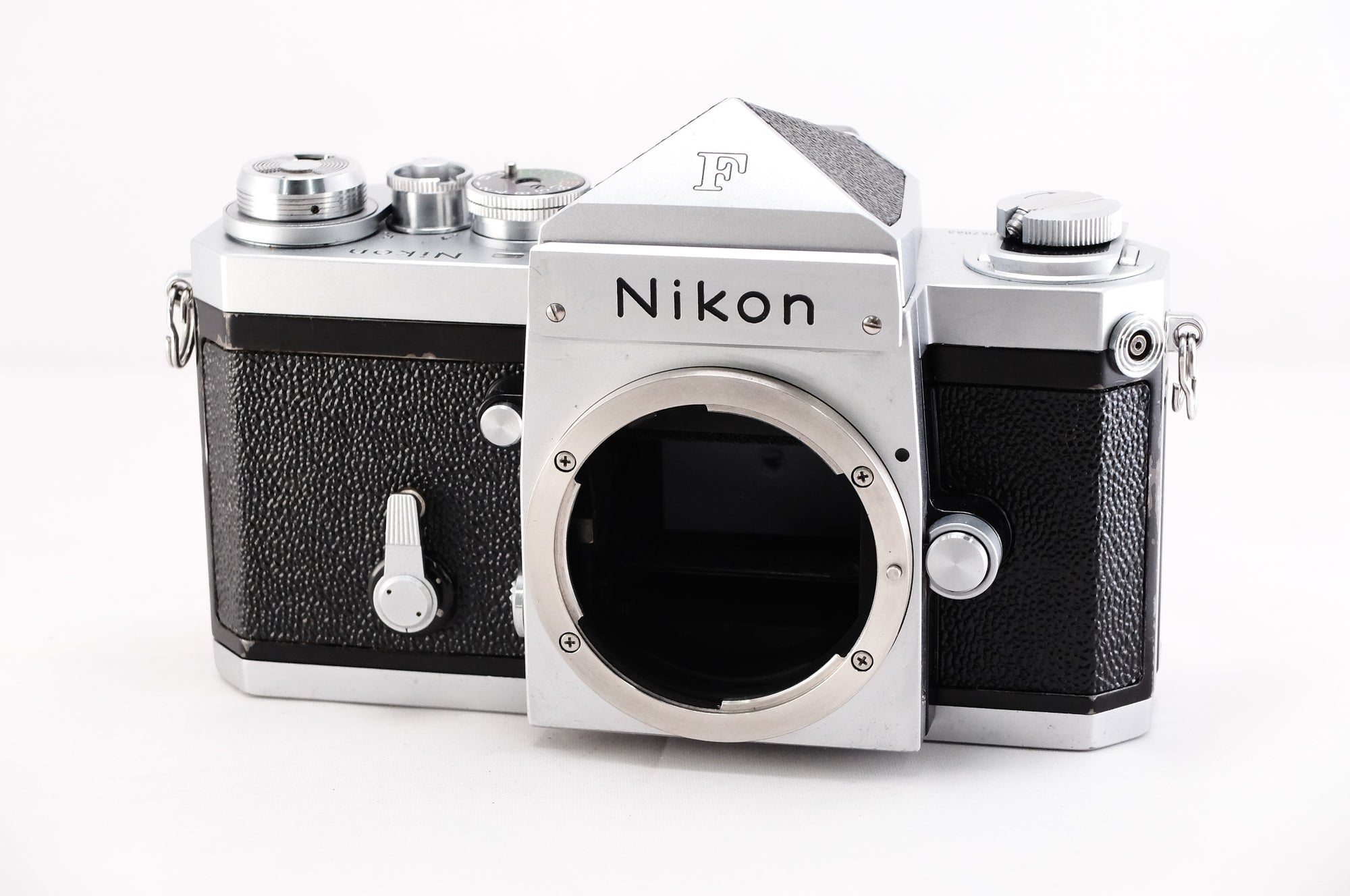 Nikon F film camera, 35mm single-lens reflex with classic design and silver finish, front view.