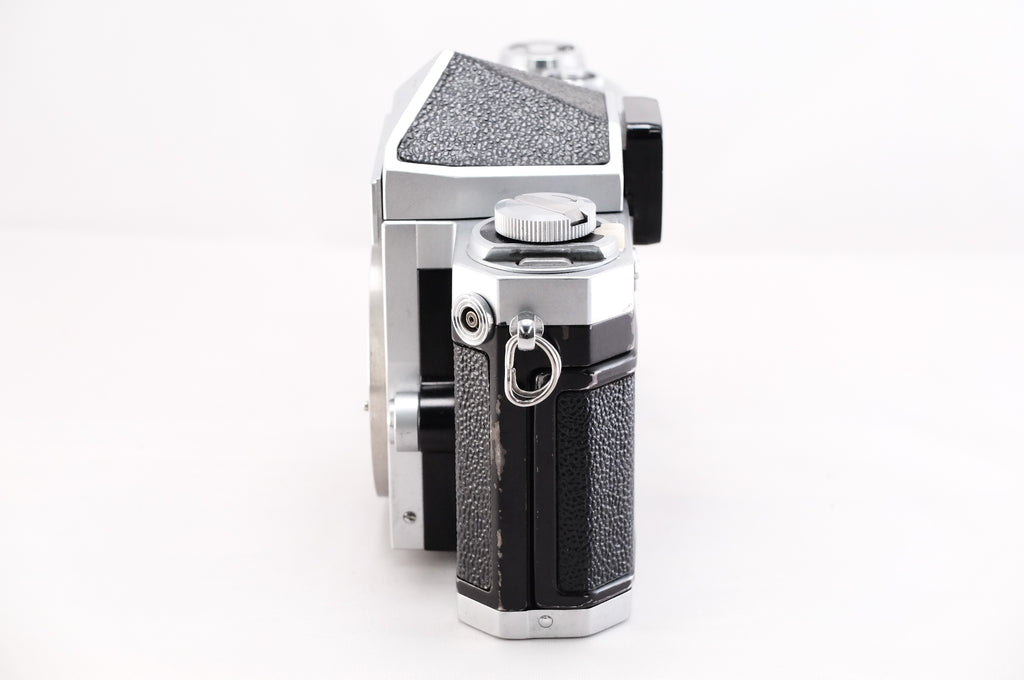 Side view of a Nikon F film camera showcasing its classic design and textured grip.