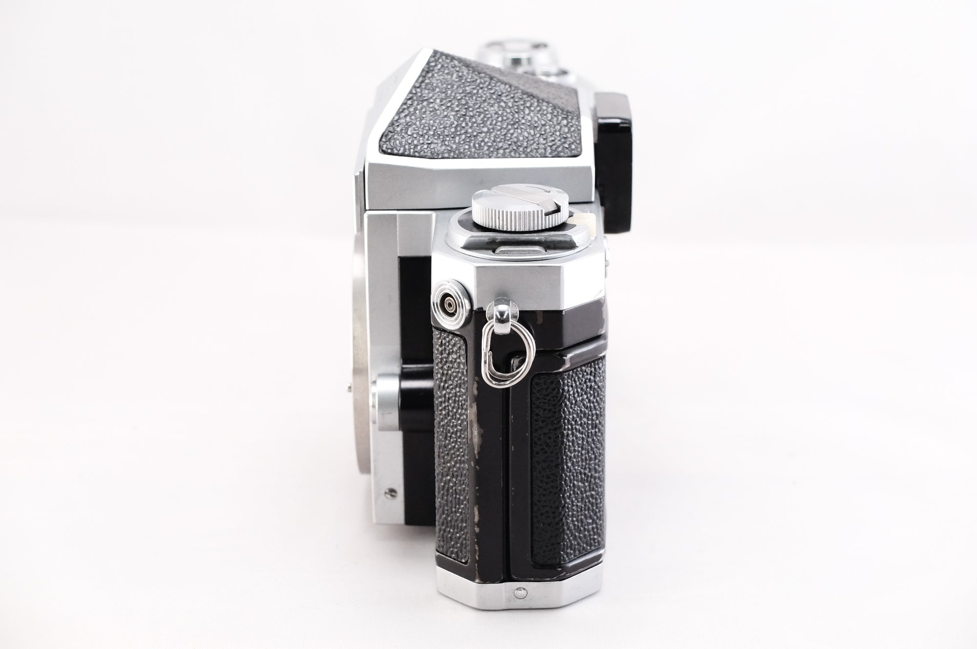 Side view of a Nikon F film camera showcasing its classic design and textured grip.