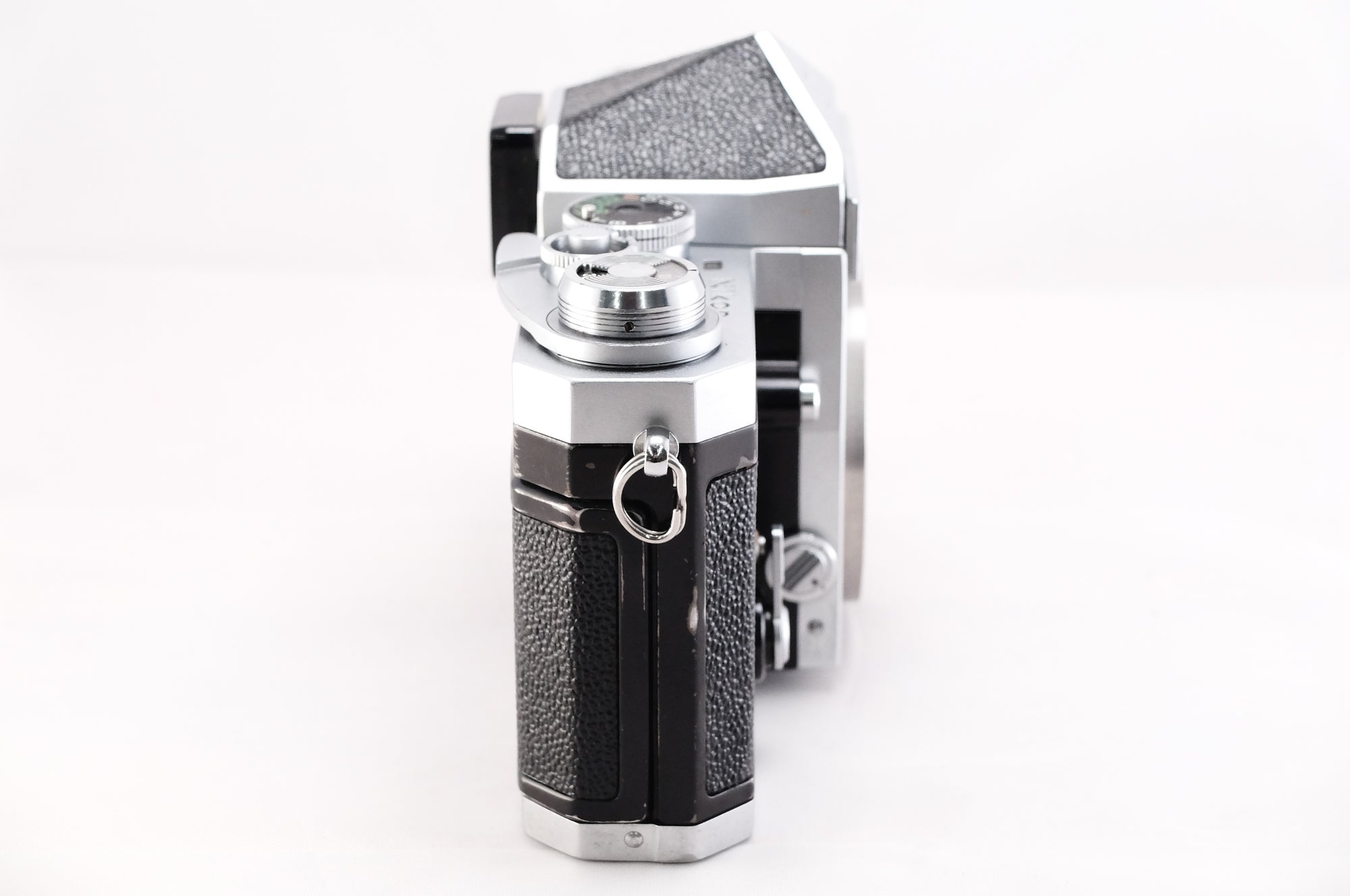 Side view of a Nikon F film camera showcasing its classic design and features.